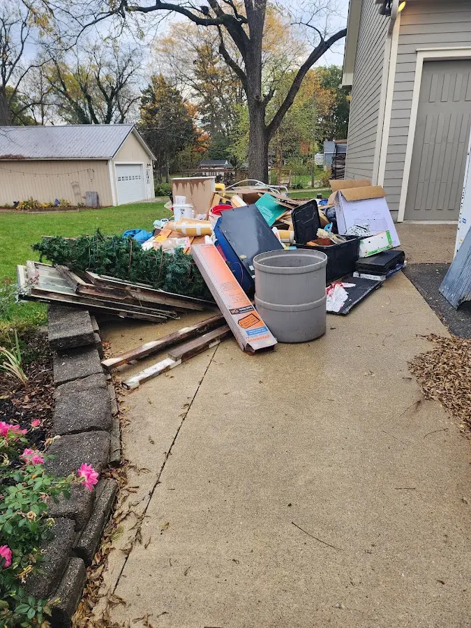 Dumpster being loaded with debris for Commercial Dumpster Rental in Auburn Hills